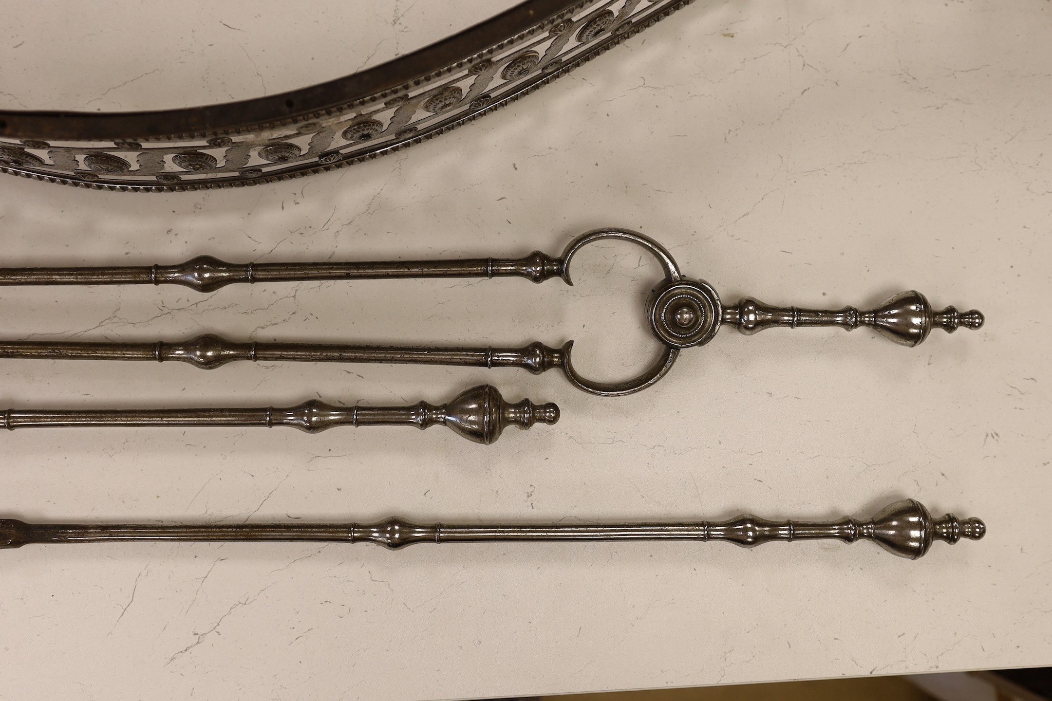 A George III polished steel fender, 109cm, and set of three fire tools